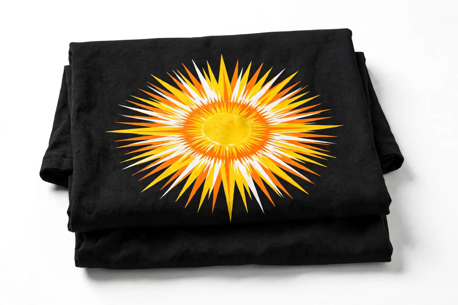 Bright sun print on a folded black t-shirt from a manufacturer in Bangladesh