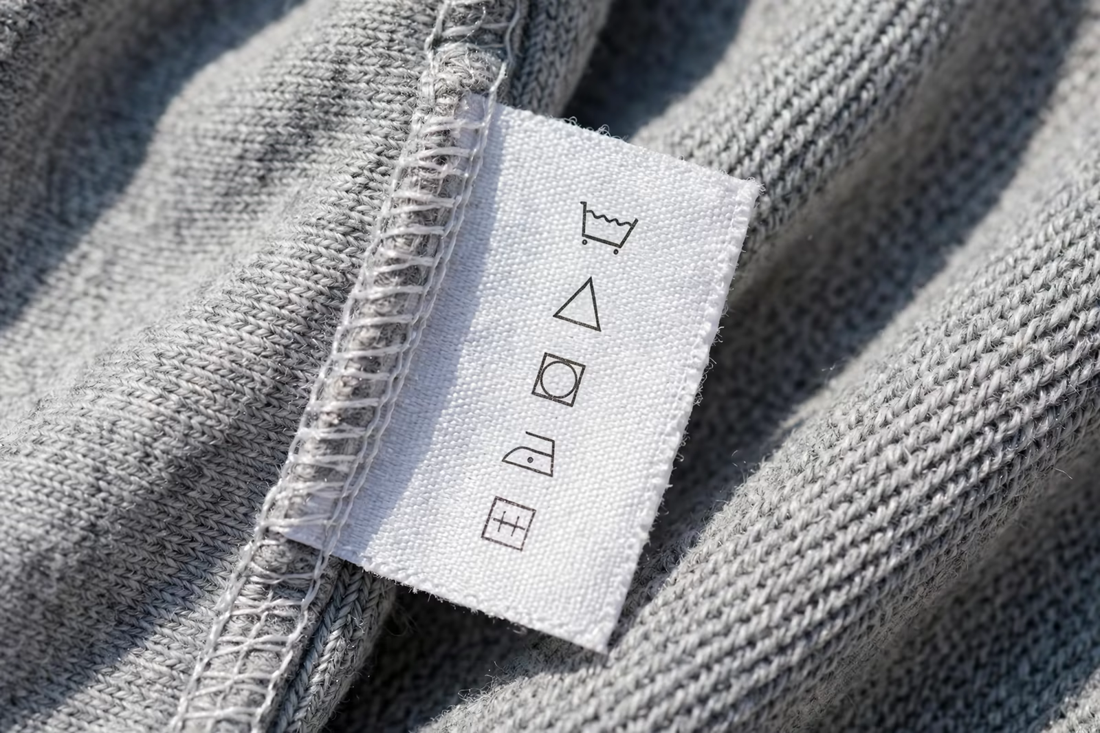 Care label with symbols sewn into a garment seam in Bangladesh