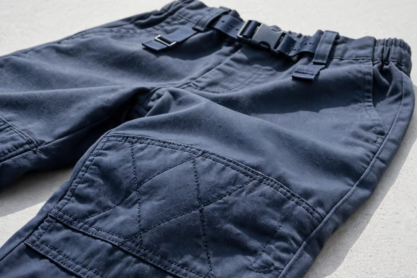 Kids school uniform trousers with a reinforced stitched knee panel and adjustable waist, produced by a clothing manufacturer in Bangladesh